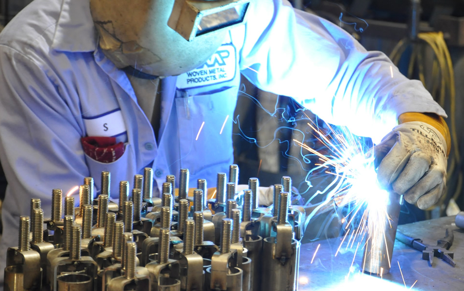 Woven Metal Products welder working on custom metal fabrications.